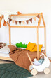 © sergiophoto - Kids room interior in contemporary, Scandinavian style. Wooden bed, sofa and toys. Cozy room for child.