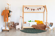 Kids room interior in contemporary, Scandinavian style. Wooden bed, sofa and toys. Cozy room for child.
