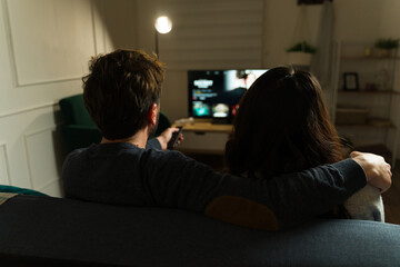 Wall Mural - Boyriend and girlfriend watching a movie on a streaming service