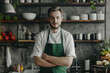© Irina B - A presentable man in a green kitchen apron. The cook is working in the kitchen. Cook in uniform, protective clothing. Catering jobs, copy space