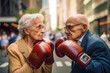 Pensioners boxing on street in USA. Grandmother boxing with grandfather. Grandma in boxing gloves in fight with broker at Wall Street. Granny boxing with a businessman. Old woman fight with old man.