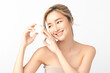 © Shutter B - Happy beautiful young Asian woman holding a cosmetic cream depicting joy and satisfaction in her skincare routine against on white background. Facial treatment, Perfect skin, Natural makeup.