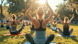 Group of people of different ages and nationalities do yoga outdoors in the park. World health day concept