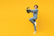 Full body side view surprised young woman she wearing grey knitted sweater shirt casual clothes hold steering wheel driving car isolated on plain yellow background studio portrait. Lifestyle concept.