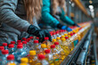 Worker meticulously inspects a sea of gleaming water bottles in a factory setting