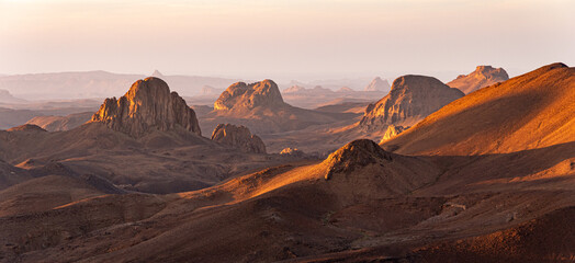 Hoggar landscape in the Sahara desert, Algeria. A view from Assekrem of the mountains and basalt organs that rise up in the morning light.