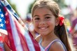 © Adriana - Smiling hispanic  little girl waving a US flag at a parade