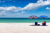 Fototapeta Sypialnia - Sunny beach with colorful umbrella and beach chairs in tropical beach