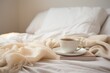 Inviting scene of a warm cup of coffee on a bed with soft linens and the gentle play of sunlight..