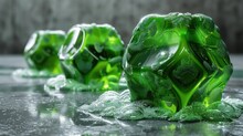 A Group Of Green Ice Cubes Sitting On Top Of A Metal Table Covered In Drops Of Water On Top Of A Shiny Surface.