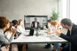 © Prostock-studio - Videoconference. Businesspeople greeting boss, waving hands to screen