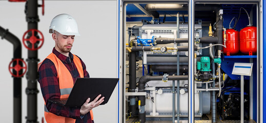 Poster - man engineer. guy near boiler equipment. factory technologist. engineer man with laptop stands near 