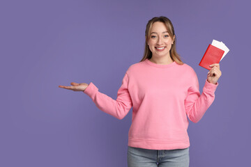 Poster - Happy young woman with passport and ticket on purple background, space for text