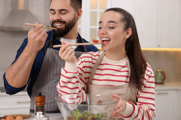 Canvas Print - Happy lovely couple cooking together in kitchen