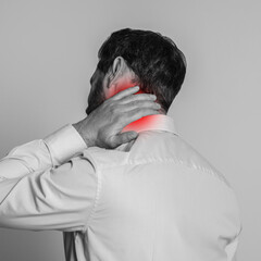 Poster - Man suffering from rheumatism on light background. Black and white effect with red accent in painful area