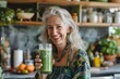 © Aliaksandr Siamko - A woman is smiling and holding a green smoothie in a glass