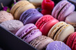 Assorted colorful macarons arranged neatly in a box