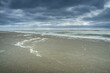 Dark clouds over sandy beach on the North Sea coast of the Netherlands