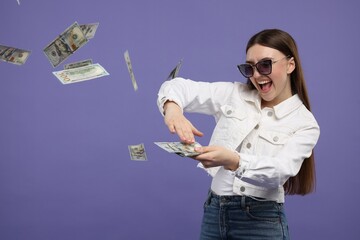 Poster - Happy woman throwing money on purple background