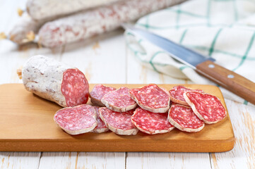 Wall Mural - traditional Spanish salami fuet sausage or dry sausage cut in slices in a kitchen table.