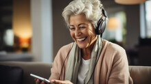 smiling elderly woman talking on smartphone via video call, pensioner, retired, old lady, grandmother calling on the phone, technology, online, internet, room at home, self-isolation
