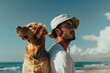 A young man and his golden retriever enjoying a sunny day at the beach
