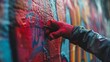 On the wall, a human hand clad in a red glove is busy drawing graffiti