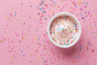Ice cream with sprinkles on pink background. Food, still life, pink, overhead.