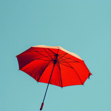 Red Umbrella Against Blue Sky Background, Floating In The Air