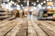 Blurred background in supermarket store with empty wooden table top