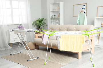 Wall Mural - Interior of room with ironing board, dryer and sofa