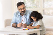© fizkes - Focused Indian grandfather and cute granddaughter kid drawing creative colorful doodles in paper album together, developing art skills, creativity, hobby, doing school homework
