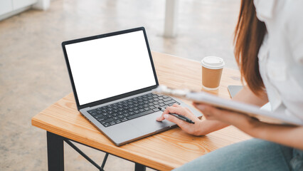 Close-up back view of a business woman working in the office typing, looking at the screen. office worker using a notebook computer..