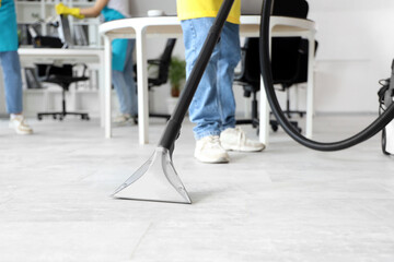 Wall Mural - Male janitor cleaning floor in office, closeup