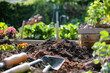 Lush Garden Scene with Rich Soil, Flowers, Composting, and Gardening Tools Under Sunlight. Composting and gardening. 