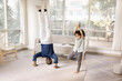 Happy active Indian dad and little daughter kid practicing yoga at home, exercising together, enjoying activity, active hobby, talking in headstand asana and tree pose