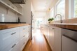 Modern and bright kitchen with white cabinetry. wooden counter Modern, beautiful, and useful kitchen utensils