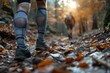 Photo of an athlete's legs in motion, running through an autumnal forest with leaves scattering among the vibrant natural scenery