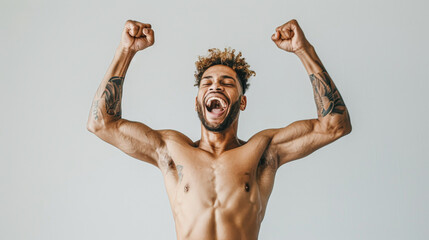 Wall Mural - A man with tattoos on his arms and chest is jumping up and down with his arms raised in the air. He is smiling and he is happy