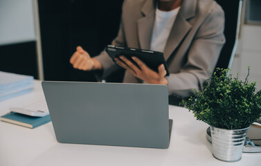 Business team working with new startup project plan and discussion information for financial strategy with laptop and digital tablet in a modern business lounge.