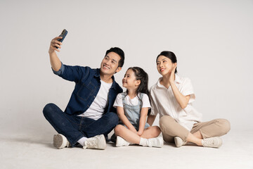 Wall Mural - Asian family portrait posing on white background