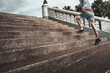 © Charnchai saeheng - A man  running up on stairs in the city center park before cardio workout.  Health and Lifestyle in big city life concept.