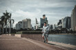 © Charnchai saeheng - A man  running up on stairs in the city center park for cardio workout.  Health and Lifestyle in big city life concept.