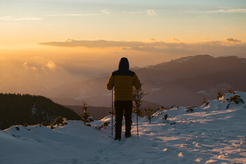 Wall Mural - Hiker in a wintry mountain landscape