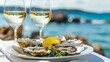 Croatian food. Fresh Oysters on white plate with lemon and and two glasses of white wine on blurred seascape 