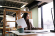 © Mihail - Diligent Office Worker Reviewing Documents at Modern Workplace During Business Hours