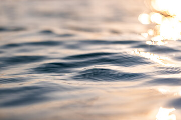 Wall Mural - beautiful closeup sea water surface. sunset sunrise gold blue colors calm soft waves relaxing horizo