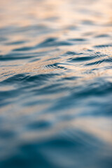Poster - Beautiful closeup sea water surface. Sunset sunrise gold blue colors calm soft waves relaxing horizon. Dream fantasy shallow focus, blur seascape sky. Tranquil peaceful nature pattern, Mediterranean
