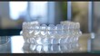 © Irina Ukrainets - Clear orthodontic aligners displayed on glass tabletop. modern dental solutions for teeth straightening. AI