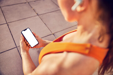 Mockup, fit athletic woman holding mobile phone with blank screen during outdoor workout